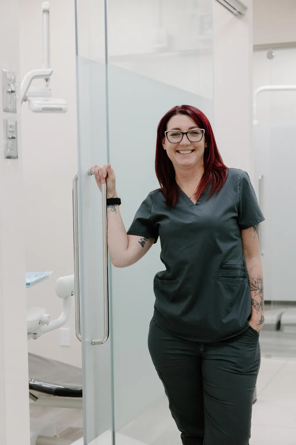 Smiles @ Southgate dental assistant smiling in a doorway